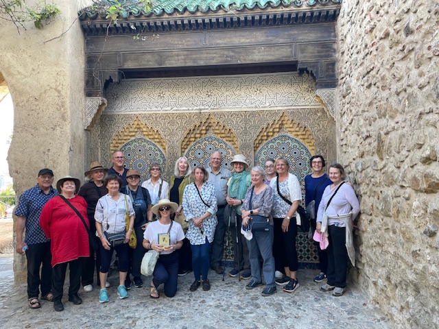 A group of people in front of an Arabic-style fountain